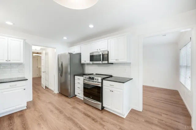 a kitchen with stainless steel appliances granite countertop a stove and a refrigerator