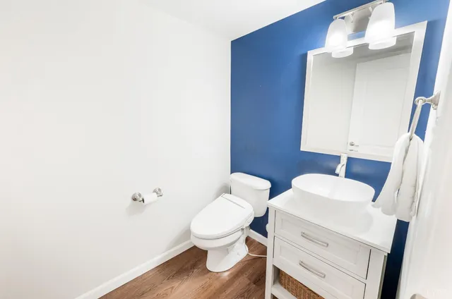 a white toilet sitting next to a bathroom sink