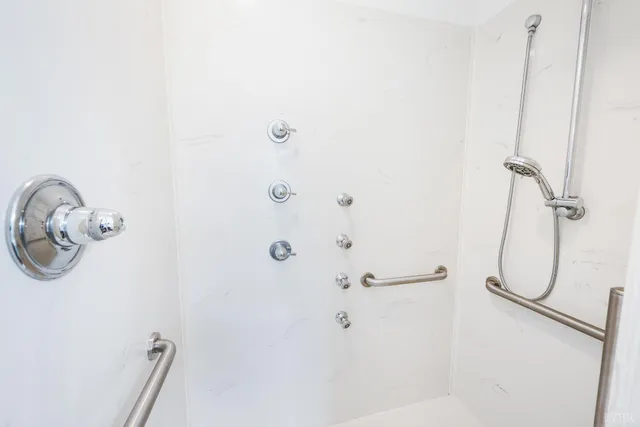 a bathroom with a shower and a shower head