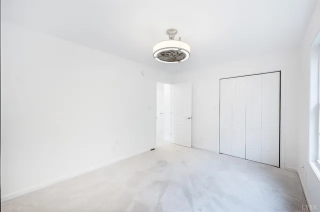 a view of a room with a fan and a window