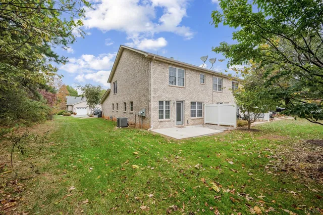 a view of a house with a yard and sitting area