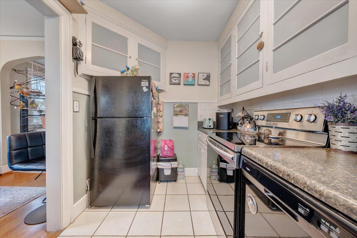 1909 Canterbury Road Southwest Roanoke, VA 24015 - Photo 29 of 65 a kitchen with granite countertop a refrigerator and a stove