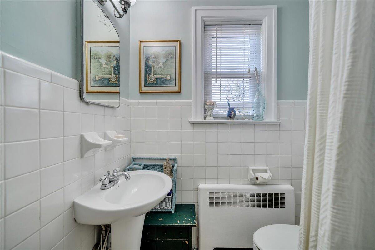 1909 Canterbury Road Southwest Roanoke, VA 24015 - Photo 32 of 65 a bathroom with a sink toilet and a mirror
