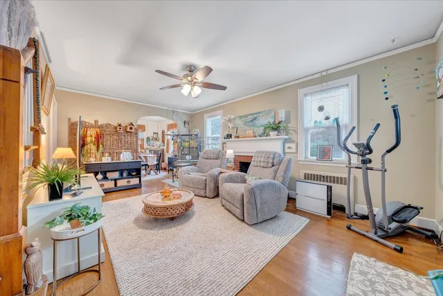 a view of a dining room with furniture a chandelier and wooden floor