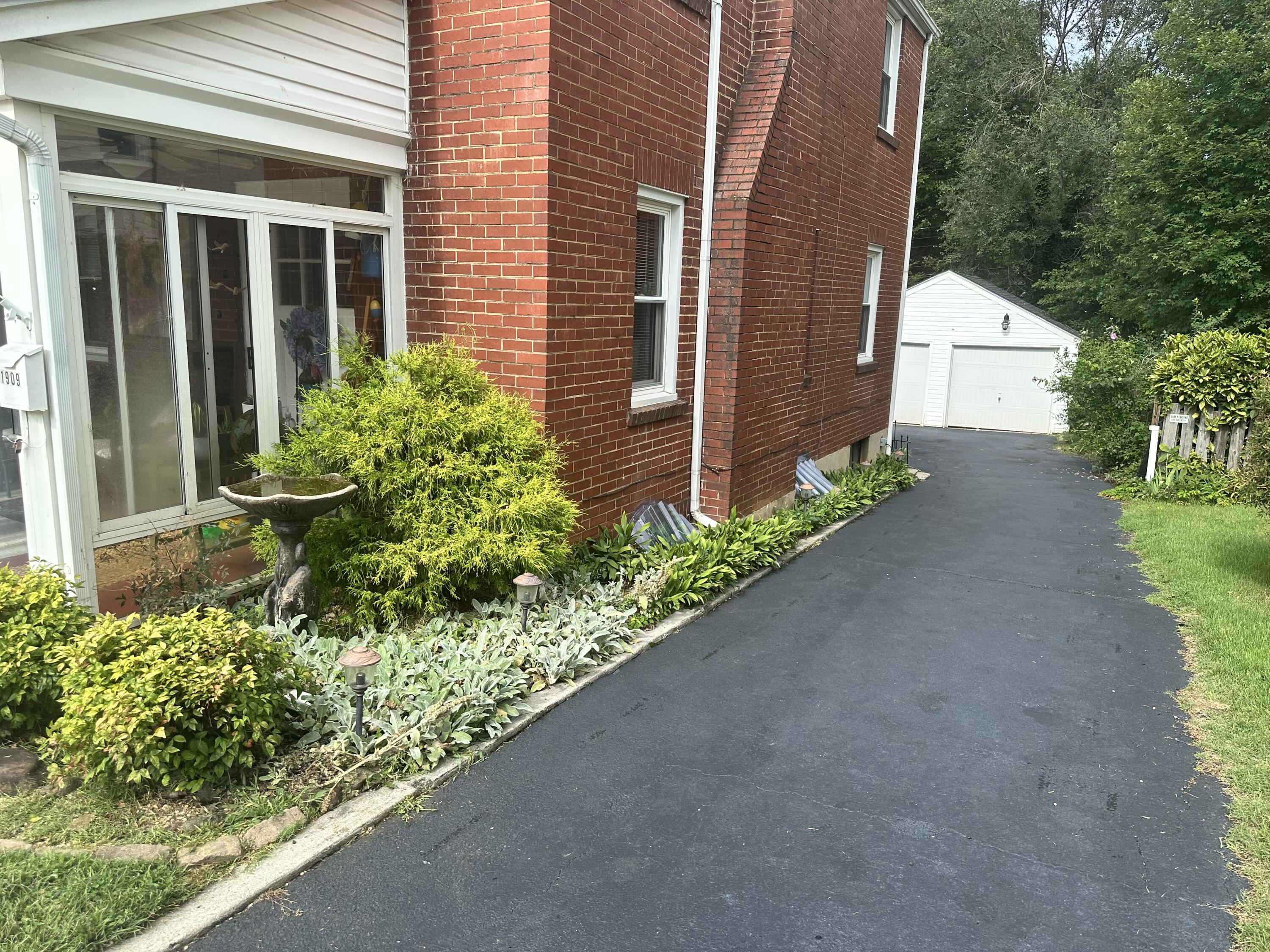 1909 Canterbury Road Southwest Roanoke, VA 24015 - Photo 64 of 65 a front view of a house with a yard and garage