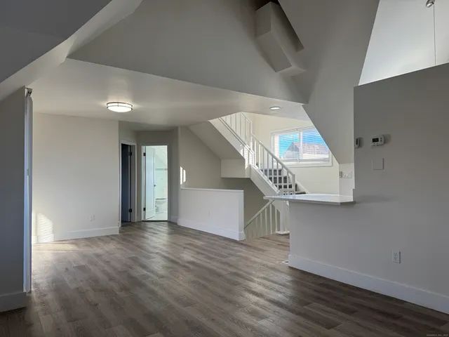 a view of an entryway with wooden floor