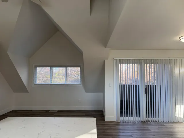 an entryway view with wooden floor and staircase