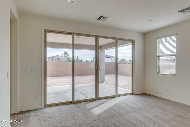 a view of an empty room with glass door