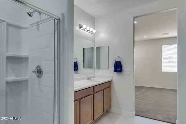 a bathroom with a sink vanity and mirror