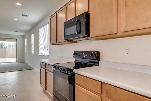 a kitchen with stainless steel appliances a stove microwave and sink