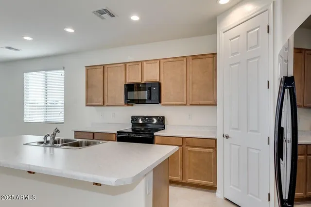 a kitchen with a sink appliances and cabinets