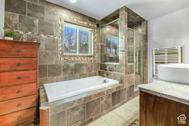 2029 West Tollgate Road Coalville, UT 84017 - Photo 24 of 43 Full bath with vanity, a shower stall, radiator, light tile patterned floors, and a bath