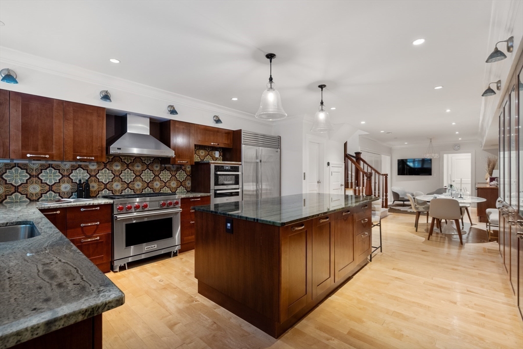 321 Beacon Street Boston, MA 02116 - Photo 18 of 34 a kitchen with stainless steel appliances granite countertop a stove a sink a oven and a dining table