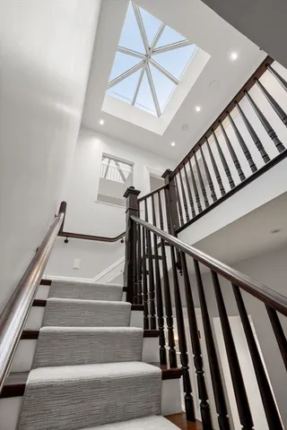 a bedroom with a large bed couch and windows