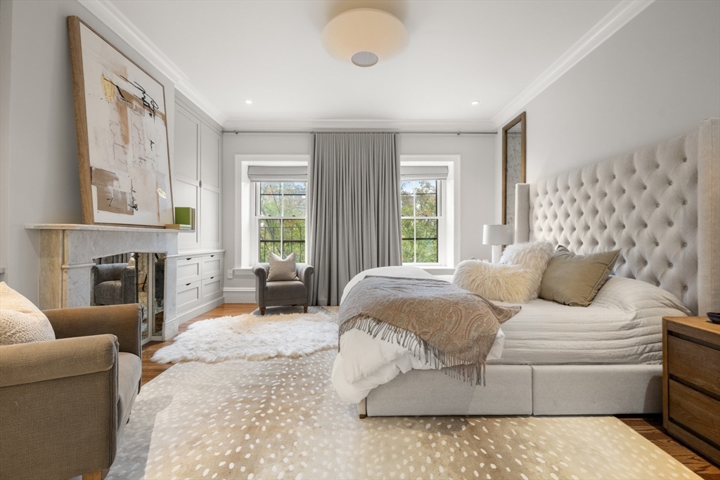 321 Beacon Street Boston, MA 02116 - Photo 22 of 34 a bedroom with a bed couches and a fireplace