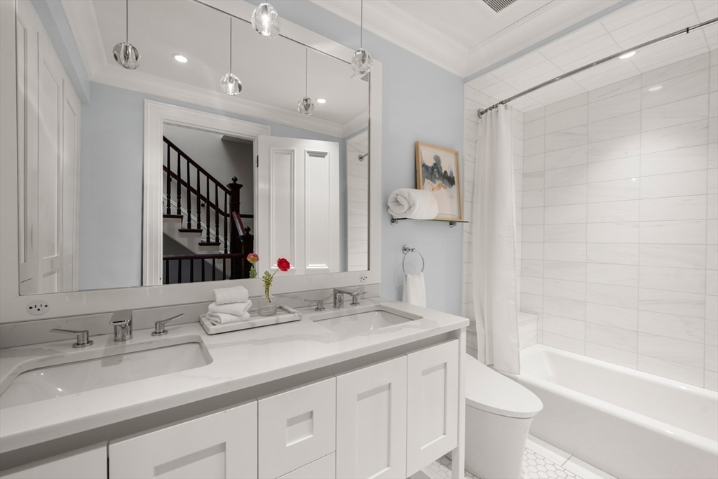 321 Beacon Street Boston, MA 02116 - Photo 26 of 34 a bathroom with a granite countertop sink a toilet and shower