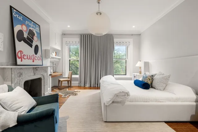 a bedroom with a bed and a fireplace