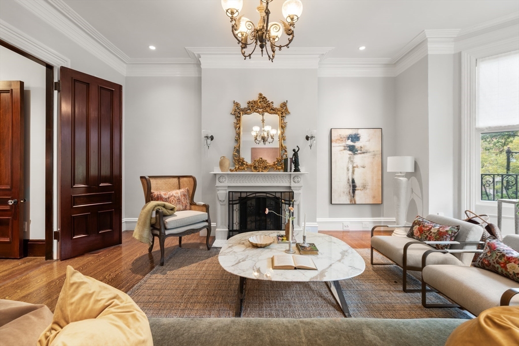 321 Beacon Street Boston, MA 02116 - Photo 5 of 34 a living room with furniture a fireplace and a large window