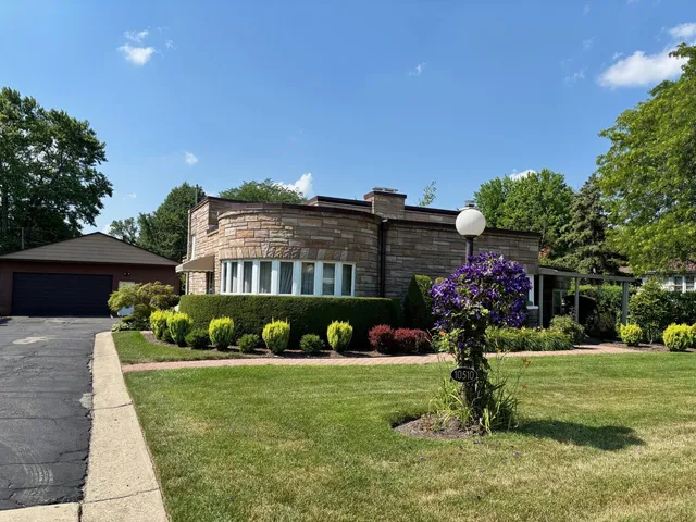 a front view of a house with a yard table and chairs
