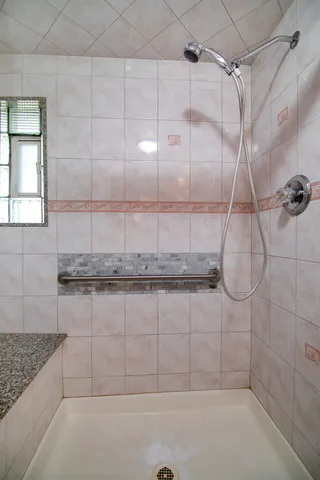 a bathroom with a shower and vanity