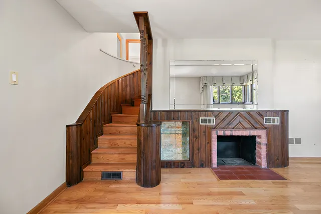 a view of entryway and hall with wooden floor