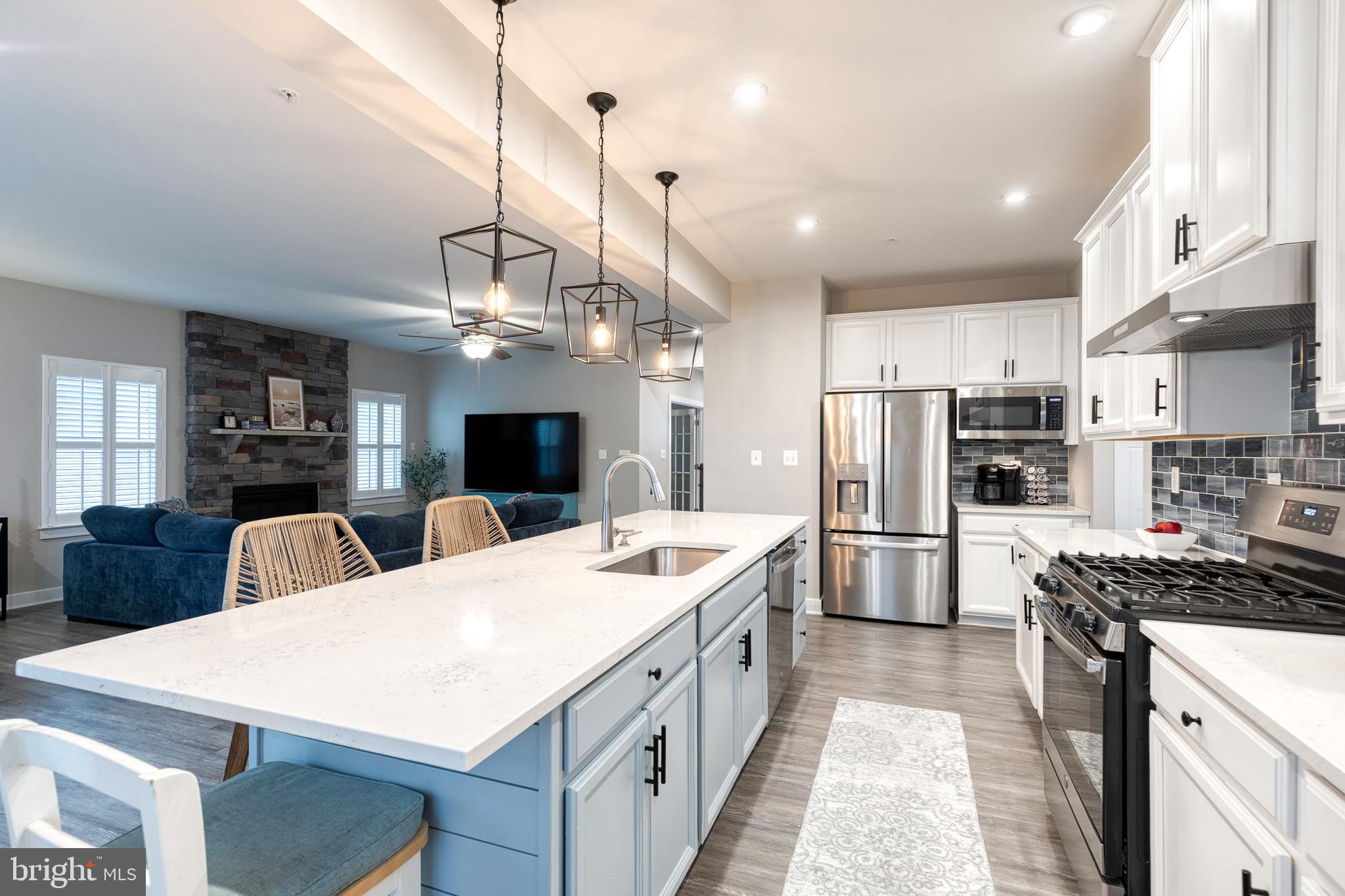 6003 Valentine Way Hanover, MD 21076 - Photo 21 of 52 a large kitchen with stainless steel appliances kitchen island a large island in the center and stainless steel appliances