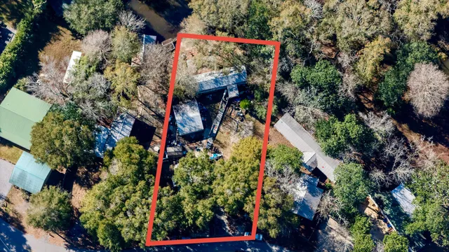an aerial view of a houses with trees