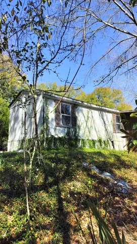 a yellow house in middle of the forest