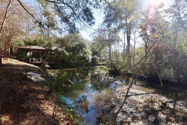 a backyard of a house with a yard and outdoor seating