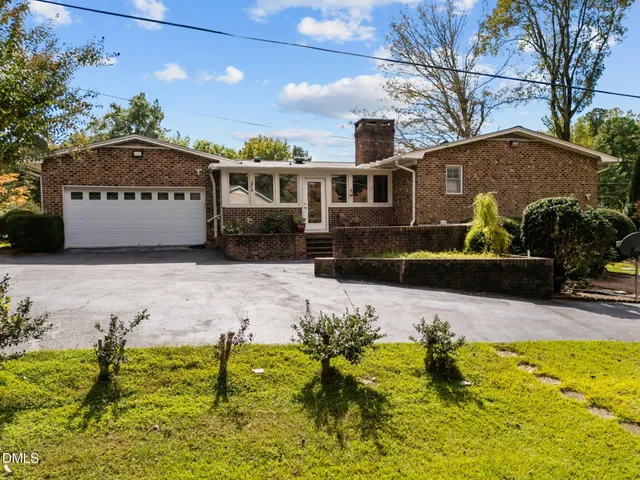 a front view of house with yard and trees