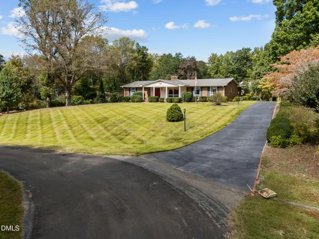 a swimming pool with outdoor seating and yard
