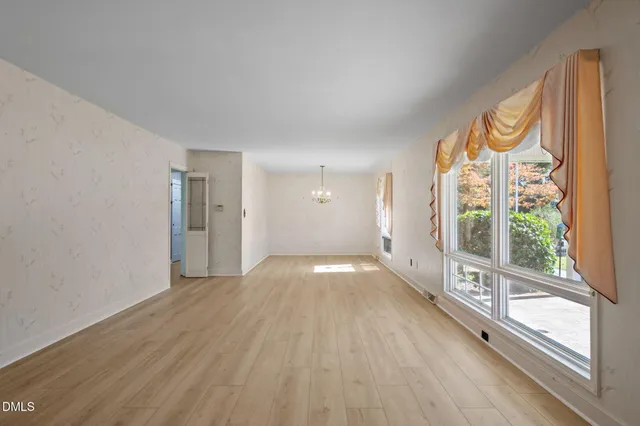 a view of a room with wooden floor and window