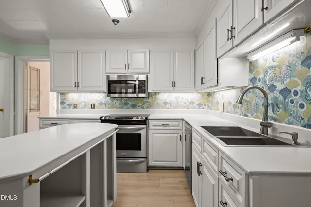 a kitchen with granite countertop a sink stove and cabinets