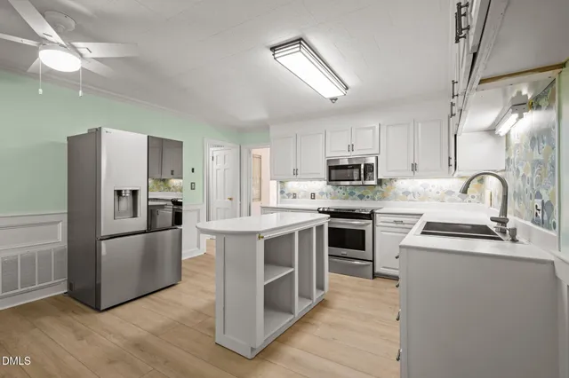 a view of an empty room with a fireplace and a window