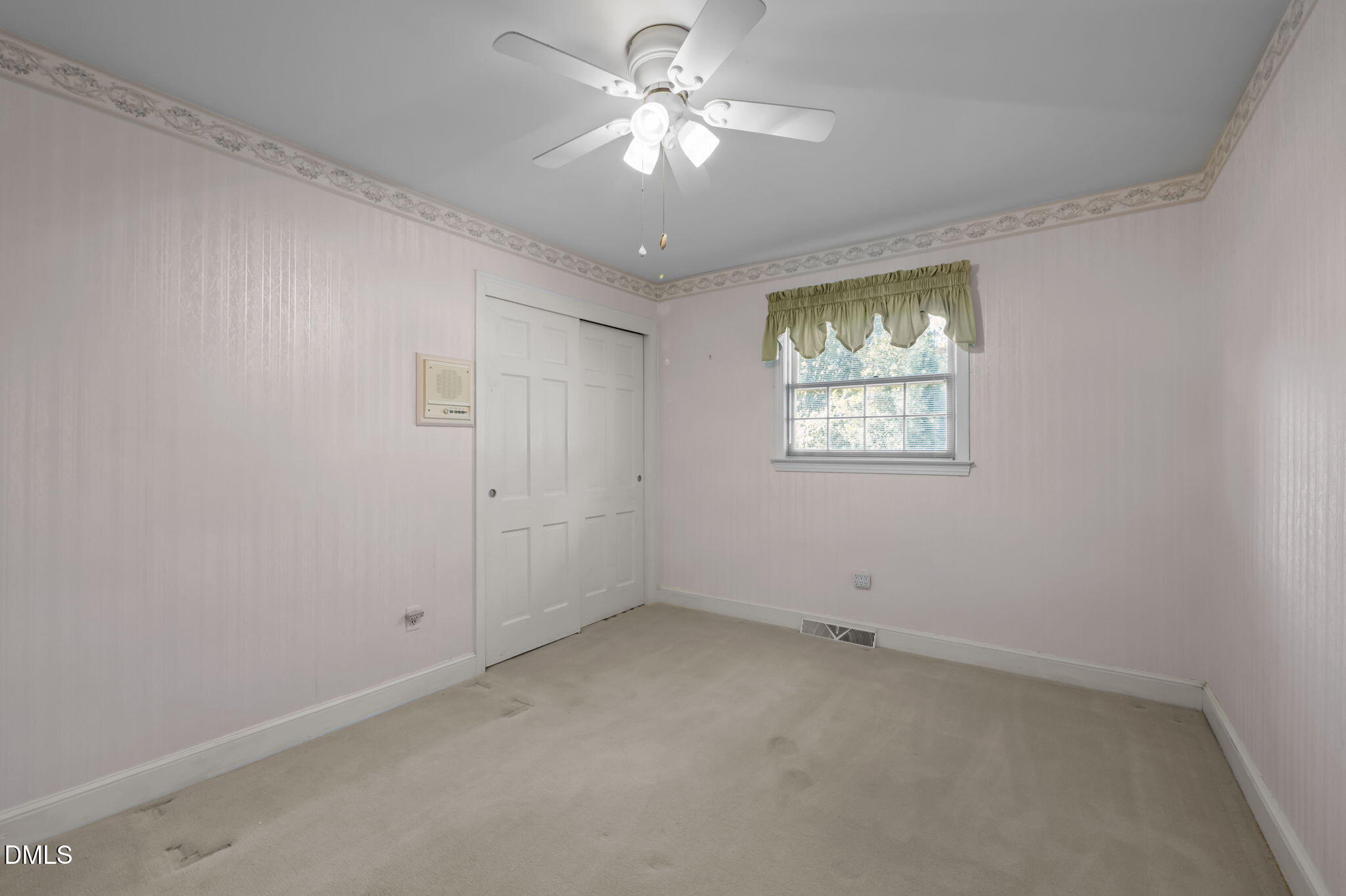 60 Banbury Court Roxboro, NC 27573 - Photo 40 of 59 an empty room with a window and a fan