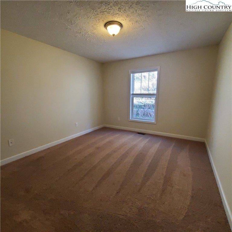 161 Alexander Drive Boone, NC 28607 - Photo 11 of 28 an empty room with wooden floor and windows