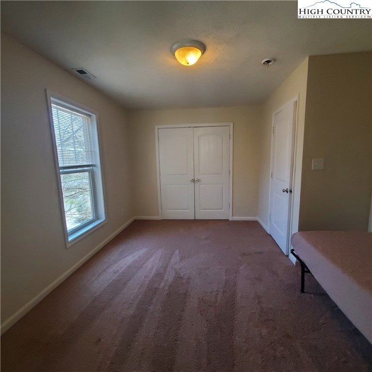161 Alexander Drive Boone, NC 28607 - Photo 19 of 28 a view of an empty room with a window and wooden floor