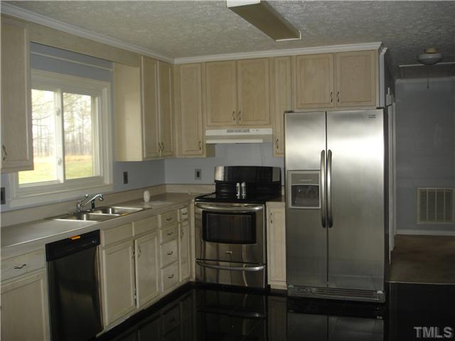 1469 Boone Road Elon, NC 27244 - Photo 6 of 17 Remodeled kitchen with new stainless steel appliances and tile flooring.