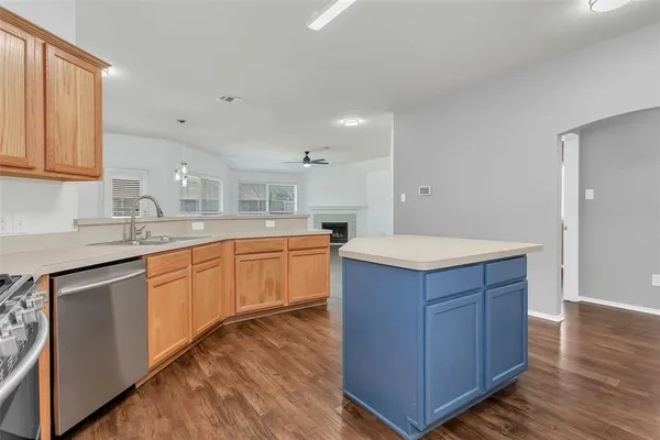 a kitchen with wooden cabinets
