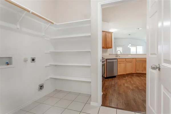 a view of kitchen with cabinets