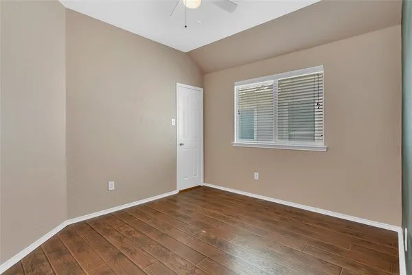 a view of a room with wooden floor