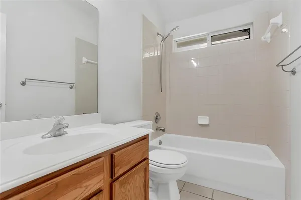 an empty room with wooden floor and a window