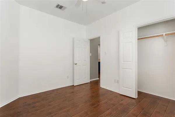 a view of a house with a large window and brick wall