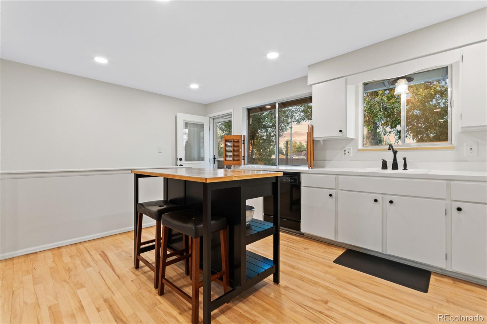5366 Field Circle Arvada, CO 80002 - Photo 12 of 50 a kitchen with a table and chairs in it