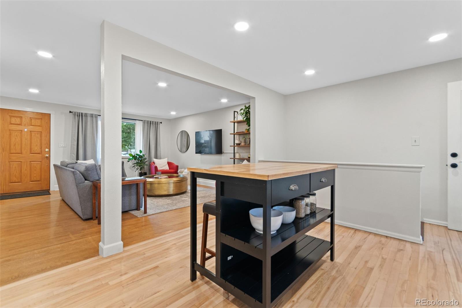 5366 Field Circle Arvada, CO 80002 - Photo 15 of 50 a living room with couches and kitchen view with wooden floor