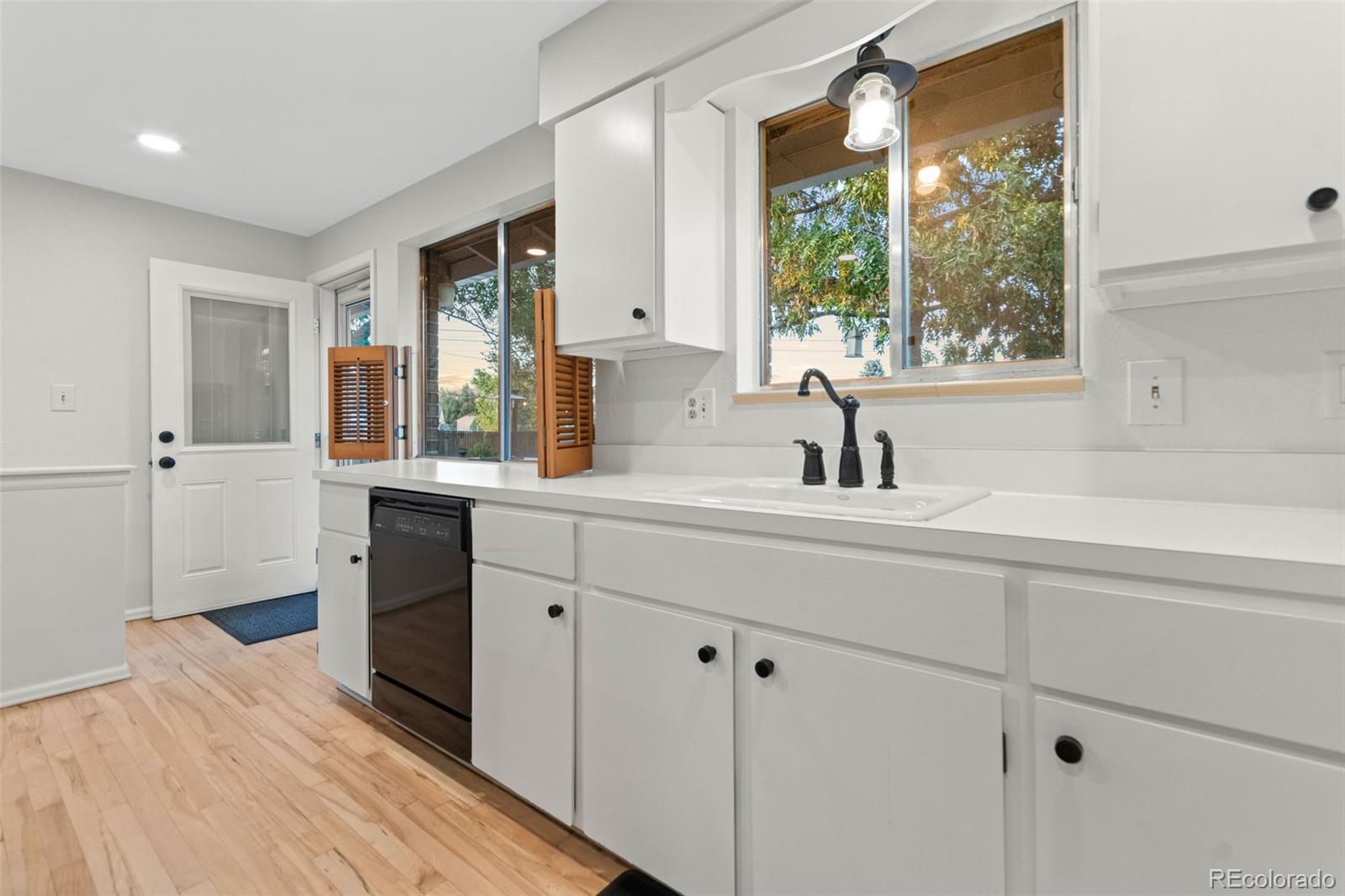 5366 Field Circle Arvada, CO 80002 - Photo 18 of 50 a kitchen with stainless steel appliances a sink stove and cabinets