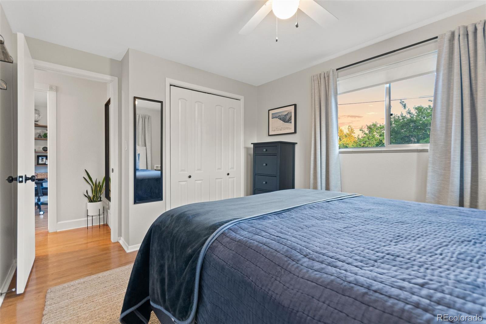 5366 Field Circle Arvada, CO 80002 - Photo 26 of 50 a spacious bedroom with a bed and a dresser next to a window
