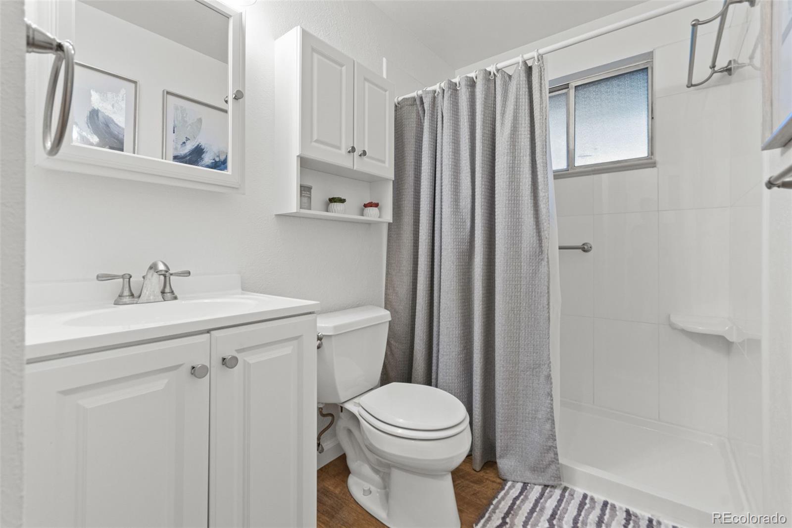 5366 Field Circle Arvada, CO 80002 - Photo 27 of 50 a bathroom with a sink a toilet and shower