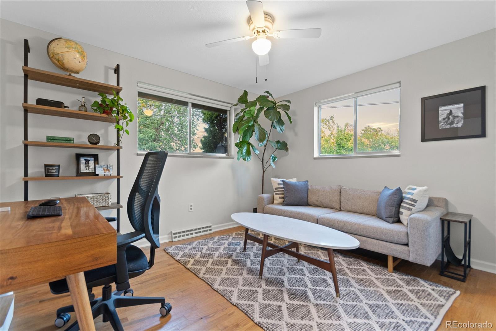 5366 Field Circle Arvada, CO 80002 - Photo 28 of 50 a living room with furniture flowerpot and wooden floor