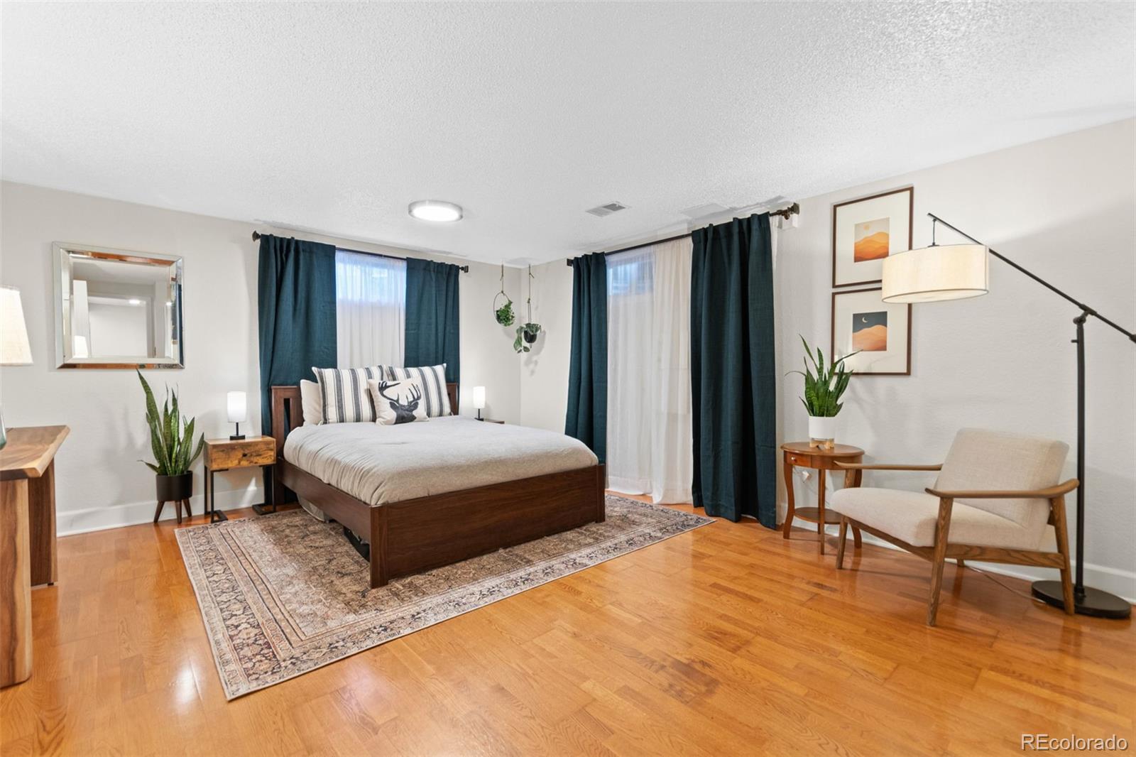 5366 Field Circle Arvada, CO 80002 - Photo 30 of 50 a bedroom with a bed a table and painting on the wall